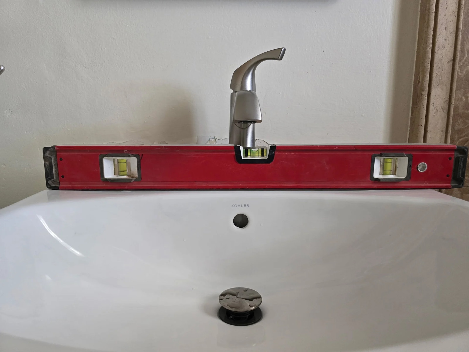Bathroom faucet being leveled during installation by Western Sky Plumbing in Phoenix