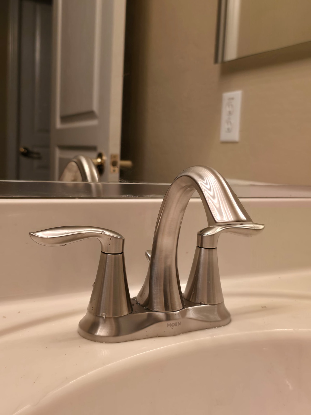 New brushed-nickel Moen bathroom faucet after replacement in a Phoenix home