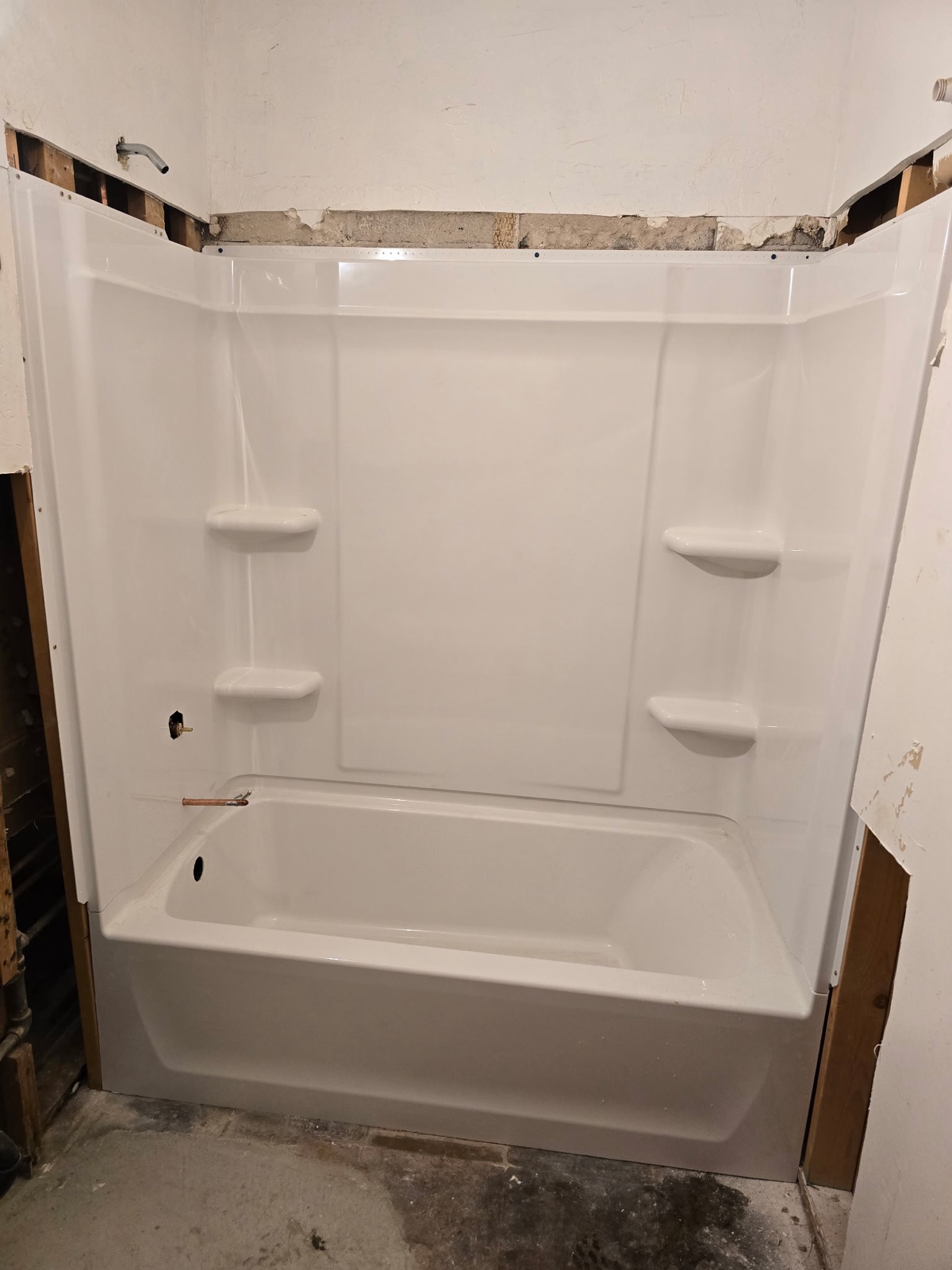 New bathtub and shower surround installed during a Phoenix bathroom plumbing job