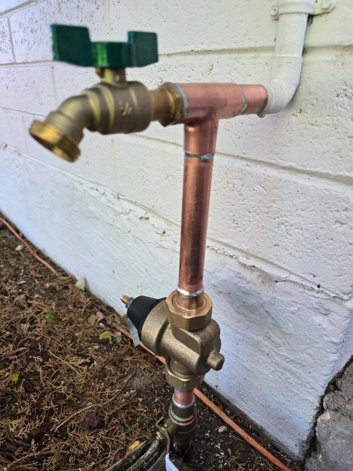 New copper hose bib and pressure reducing valve installed on a Phoenix home