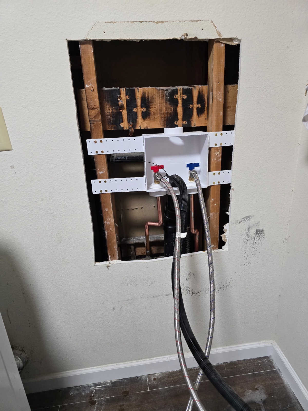 New washer outlet box and supply lines after an in-wall water leak repair in Phoenix