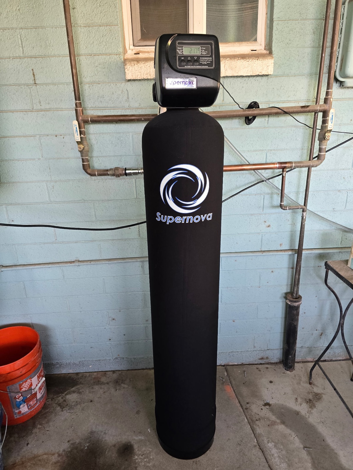 Supernova water softener installed outdoors on a Phoenix home's main water line