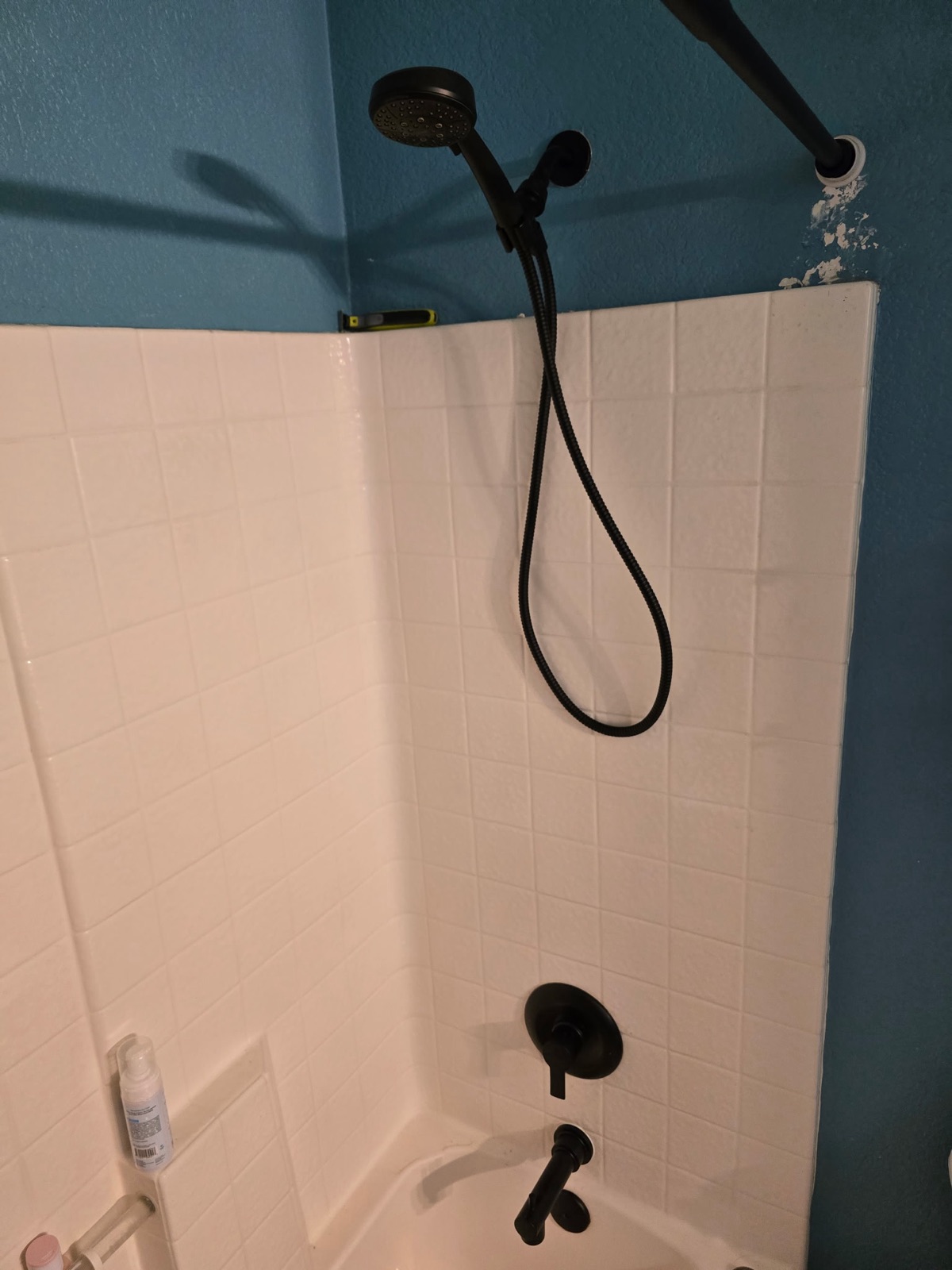 Matte black shower head and tub valve trim replaced in a Phoenix bathroom