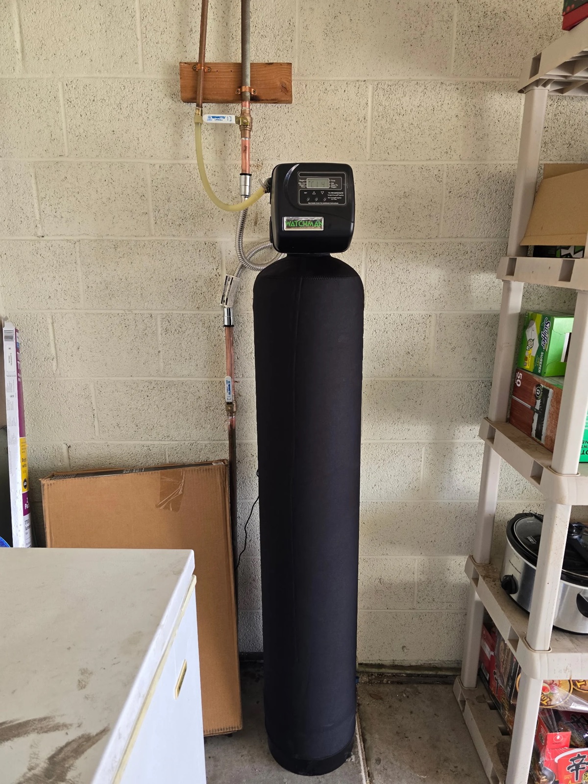 Whole-house water treatment tank installed in a Phoenix garage by Western Sky Plumbing